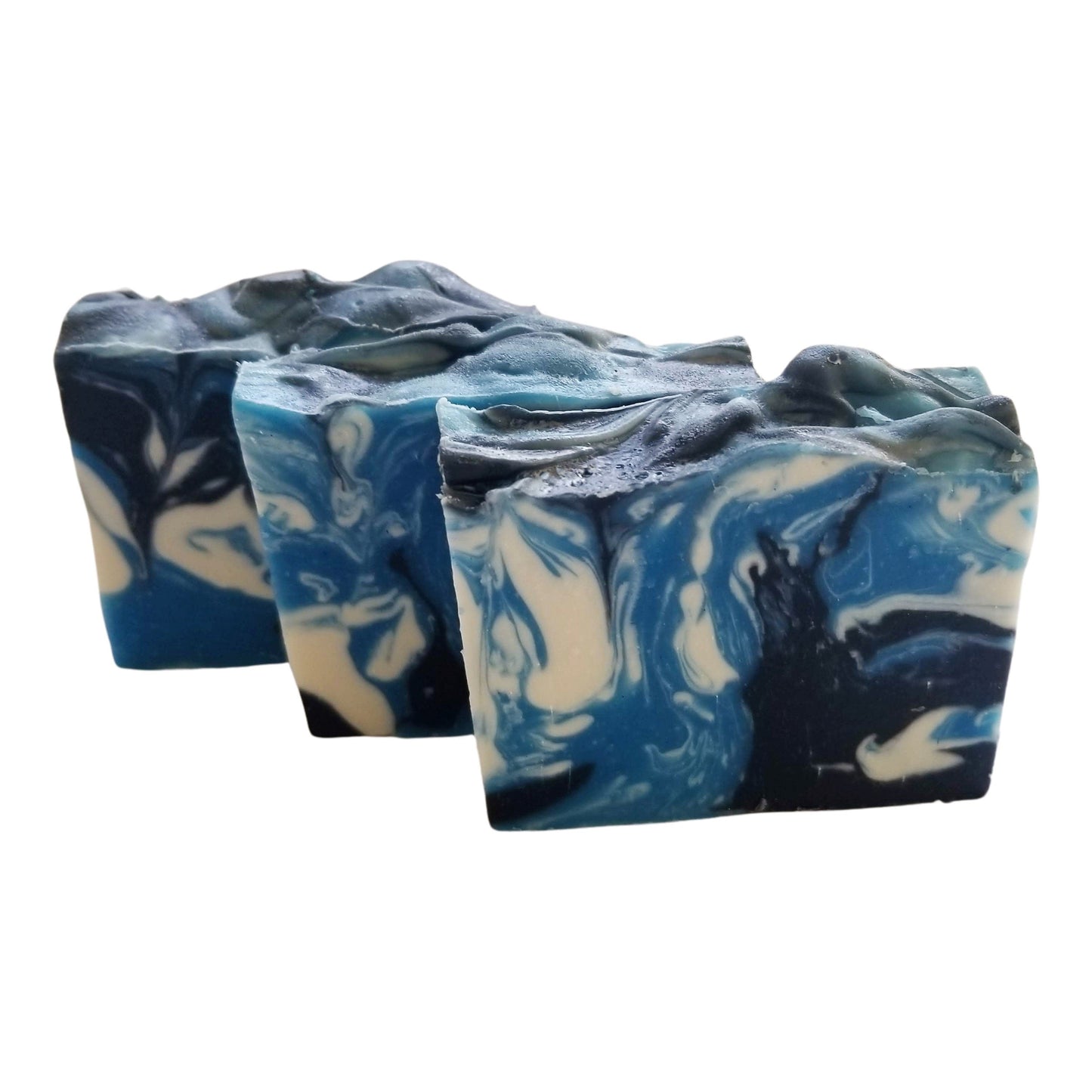 Sandalwood Spirit Soap – Earthy. Elegant. Enchanting a handcrafted, cold-process bar that soothes the soul and skin alike. Swirled in deep oceanic blues with activated charcoal and kaolin clay