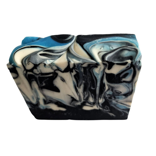 Sandalwood Spirit Soap – Earthy. Elegant. Enchanting a handcrafted, cold-process bar that soothes the soul and skin alike. Swirled in deep oceanic blues with activated charcoal and kaolin clay